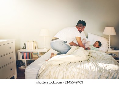 I Got You. Shot Of A Cheerful Father And Daughter Having A Tickle Fight On The Bed At Home.