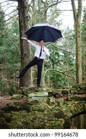 Goth Guy In Business Clothes Dances With An Umbrella