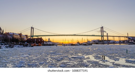 Gothenburg - Beautiful sunset at frozen Gota river with Hisingsleden Bridge in the harbor district during winter