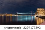  Gothenburg Midnight Skyline with Outlook over illuminated Alvsborgs Bridge reflecting in water of Gota Alv River in Sweden. 