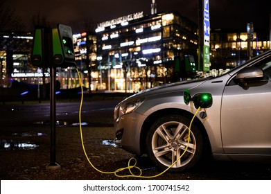 Gothenburg, Sweden, 02 02 2020: A Volvo Electric Car Is Charging In Front Of A House With Lots Of Lights At Night