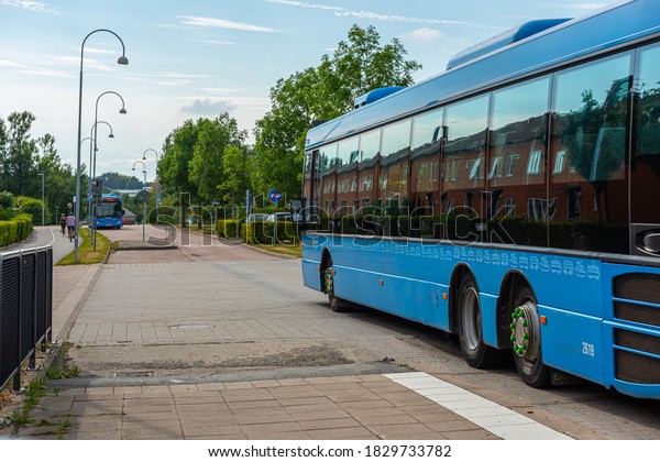 Gothenburg, Sweden - August 19 2020: Two buses\
meeting at a bus\
stop