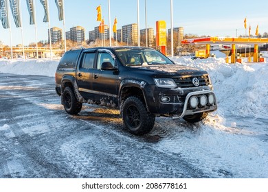 Gothenburg, Sweden - december 04 2021: Black VW Amarok pickup truck on a parking lot in winter.