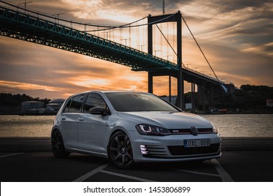 Gothenburg, Sweden - July 21, 2018: Scenic photo of a Volkswagen Golf GTI with a bridge in the background