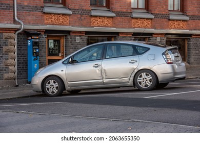 Gothenburg, Sweden - October 23 2021: Grey Beat Up Toyota Prius Hybrid Car.