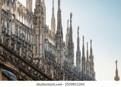 Gothic architecture of Milan Cathedral with spires, statues, pinnacles and ornate decorations, Milan, Lombardia, Italy. Close up of Duomo di Milano with intricate detailed architecture - Powered by Shutterstock