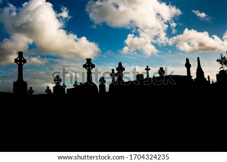 Gothic Celtic crosses against a clouded sky in an old Protestant cemetery on top of a hill in Ennistimon, County Clare, Ireland.