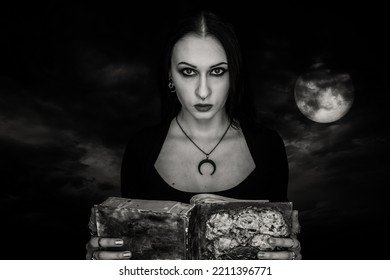 Gothic Girl Wih Spell Book Over Dramatic Night Sky. Photo Of The Moon: NASA.