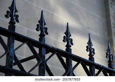gothic iron gate with repeating pattern against a stone background - Powered by Shutterstock