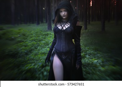
Gothic model in the woods, the blue lights. Vampire stories. The girl in a black hood and shouting blue conjures magic. Photo illustrations in fantasy style.
photoshoot for Halloween