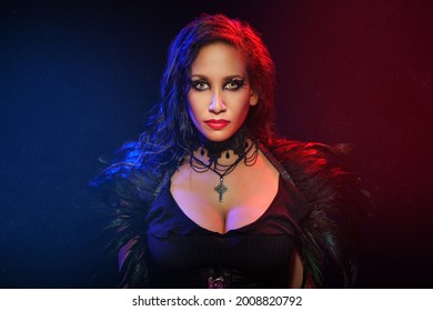 Gothic Sexy Young Woman Portrait. Halloween. Beautiful Model Girl With Fantasy Makeup In Goth Costume With Black Feathers. 