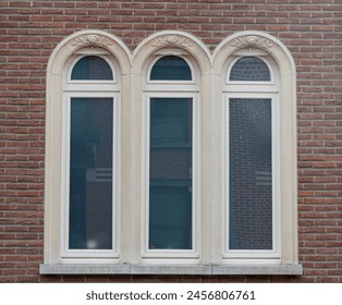 Gothic style arched window,brick wall with windows, windows on the red wall, windows on red brick in an abandoned building - Powered by Shutterstock