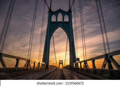 Gothic Style Arches Tracery St Johns Bridge And A Car With Beautiful Sunrise In Portland, Oregon.