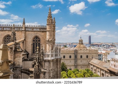 Gothic style with typical decoration in the Cathedral of Seville with windows and flying buttresses, in the background dome and courtyard of orange trees, SPAIN - Shutterstock ID 2231636789