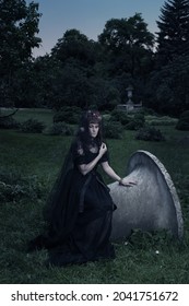 Gothic Woman In Mysterious Place, Long Black Victorian Dress Create Dramatic Atmosphere. Classic Horror Scene.