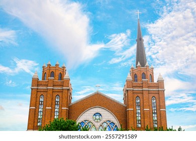 Gothic-style church in suwon, korea. the image captures the church's exquisite brick architecture and spire under a clear blue sky. - Powered by Shutterstock