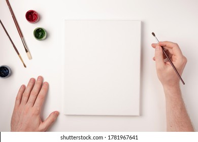 Gouache, brushes, white canvas on white background. Hand drawing on white canvas. Copy space. Top view. Flat lay. - Powered by Shutterstock