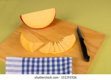 Gouda Cheese Wedge On A  Chopping Board