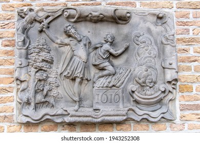 Gouda, The Netherlands-March 2021; Close up view of a stone tablet (Abraham and the sacrifice or binding of his son Isaac) in the wall of the historic Lazaruspoortje as part of the city museum