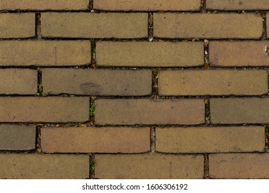 Gouda, South Holland/The Netherlands - Close Up Top Down Show Of A Side Walk Made Of Small Brown Old Fashioned Stones With Sand And Dirt In The Cracks Between The Stones