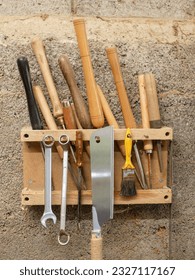 Gouges and various woodturning tools, stored on a homemade wall rack - Shutterstock ID 2327117167