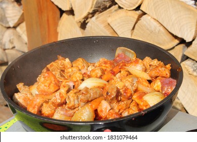 goulash with carrots and onions in a pan