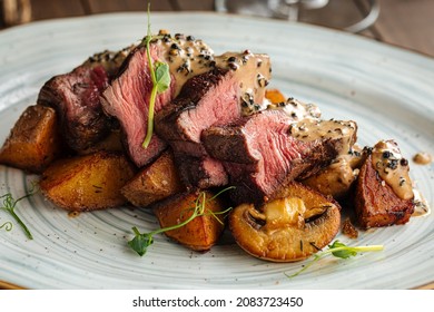 Gourmet beef medallions dish with potatoes and mushrooms