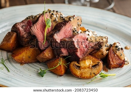 Gourmet beef medallions dish with potatoes and mushrooms