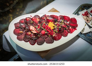  Gourmet beet salad with artistic presentation, featuring red beet slices, herbs, and garnish on a white plate.  - Powered by Shutterstock