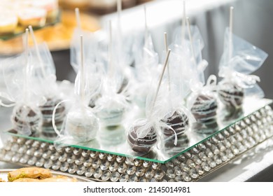 Gourmet Chocolate Covered Cake Pops  Arranged On A Fancy Mirror Pedestal On A Dessert Table For A Luxury Wedding Party Dinner