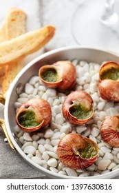 Gourmet Food, Escargot Snails With Herbs Butter In Aluminum Pan On Marble Background