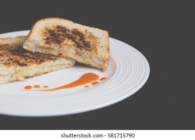 Gourmet Grilled Cheese Sandwich With Pepper Jack Cheese On A White Plate And Black Background