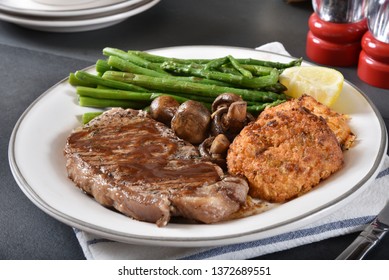 Gourmet Grilled Rib Steak With Lobster Cakes And Asparagus