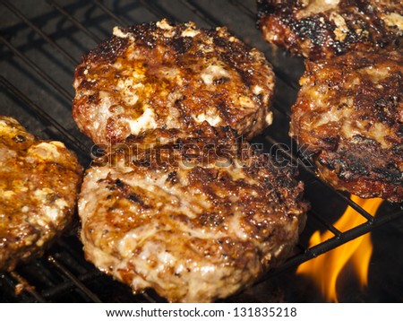 Gourmet hamburger parries on the grill.