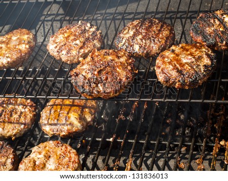 Gourmet hamburger parries on the grill.