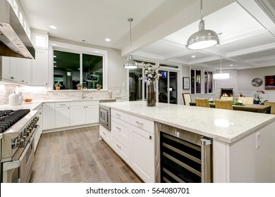 Gourmet kitchen features white shaker cabinets with marble countertops, stone subway tile backsplash and gorgeous kitchen island. Northwest, USA