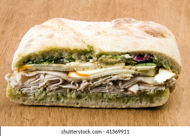 Gourmet Ovengold Roast Turkey Sandwich With Muenster Cheese Sliced Avocado Spring Mix Pesto Mayonaisse On Ciabatta Bread