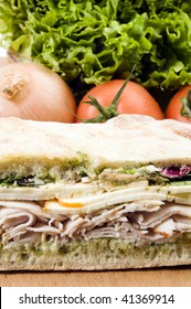 Gourmet Ovengold Roast Turkey Sandwich With Muenster Cheese Sliced Avocado Spring Mix Pesto Mayonaisse On Ciabatta Bread