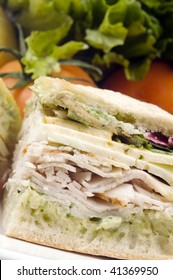 Gourmet Ovengold Roast Turkey Sandwich With Muenster Cheese Sliced Avocado Spring Mix Pesto Mayonaisse On Ciabatta Bread