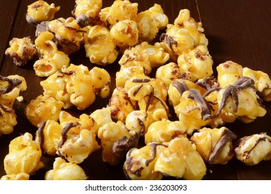 Gourmet Popcorn With Carmel And Chocolate On A Rustic Wooden Table