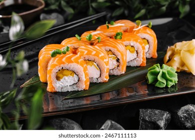Gourmet salmon sushi rolls served on a black plate with garnishes, ready for a fine dining experience