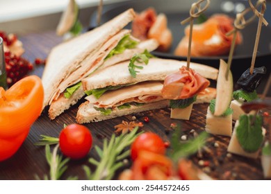 A gourmet sandwich displayed with appetizers, pomegranate seeds, rosemary, and vegetables on a rustic wooden surface, offering a stylish food presentation.
 - Powered by Shutterstock