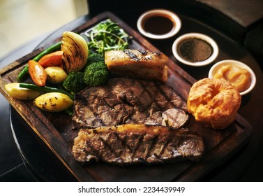 gourmet sunday roast beef traditional british meal set on old wooden pub table - Shutterstock ID 2234439949