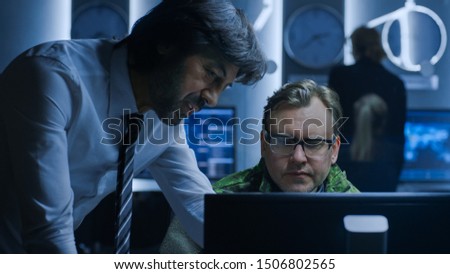 Government Chief of Cyber Security Agent Consults Military Officer who Works on Computer. Specialists Working on Computers in System Control Room.