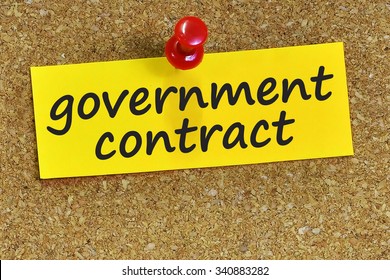 Government Contract Word On Yellow Notepaper With Cork Background.