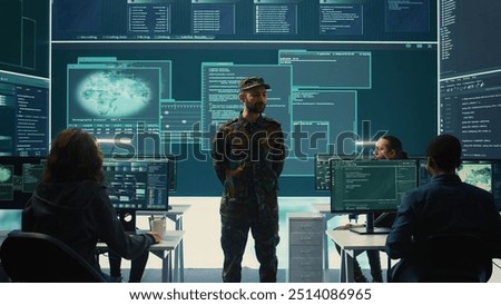 Government military hackers engaged in hybrid warfare strategies. Using sophisticated software and technology to secure information, prevent breaches and protect military operations. Camera B.