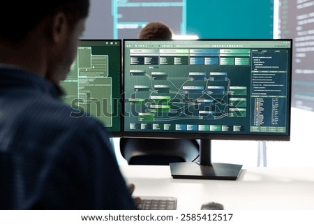 Governmental hacker expert securing computer systems from cyber attacks, working in monitoring center control room. Man focusing on encryption and espionage against cyber threats.
