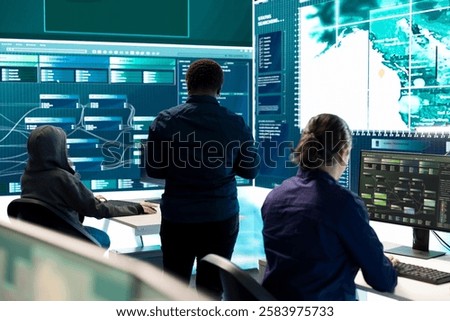 Governmental hackers exploiting network systems in high tech office, executing cyber operations for national server security. Focus on data protection and online safety to combat cybercrime.