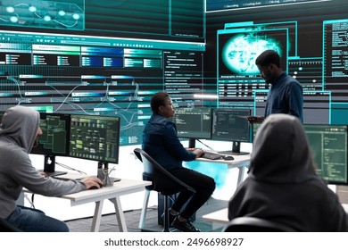 Governmental hackers using advanced software to protect against cyber threats, working in team. Specialists on cyber security, data and network protection unite forces in high tech office.