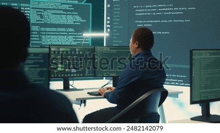 Governmental hackers using advanced software to protect against cyber threats, working in team. Specialists on cyber security, data and network protection unite forces in high tech office. Camera A.